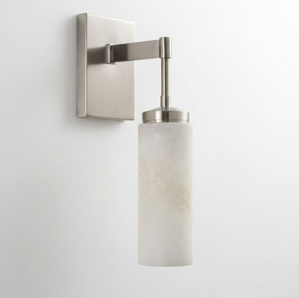 This Clérachic sconce in brushed nickel shows its right-angle arm and cylindrical alabaster shade against white.
