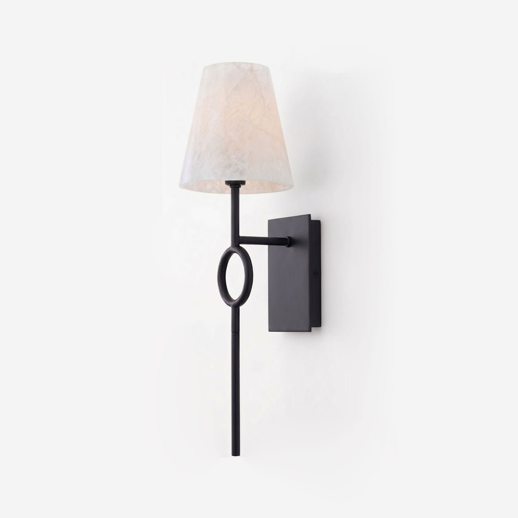 On a plain grey backdrop, this Clérachic wall sconce shows its matte black rod and oval ring beneath a tapered alabaster shade.