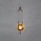 This Clérachic wall sconce is photographed against a plain grey wall, showing the full loop from wall bracket to lit base.