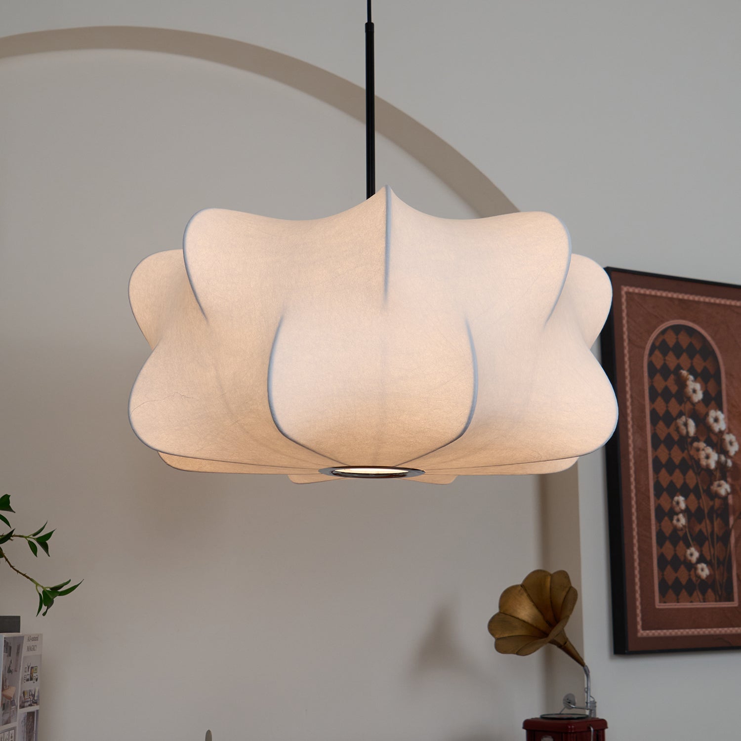 Elysia pendant light suspended above a dining table at dusk