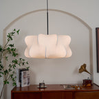 Elysia pendant light with its silk shade glowing in a styled room