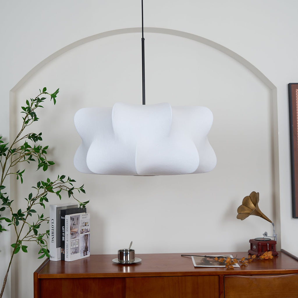 Silk cocoon pendant light glowing in a warm living room