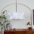 Silk cocoon pendant light glowing in a warm living room