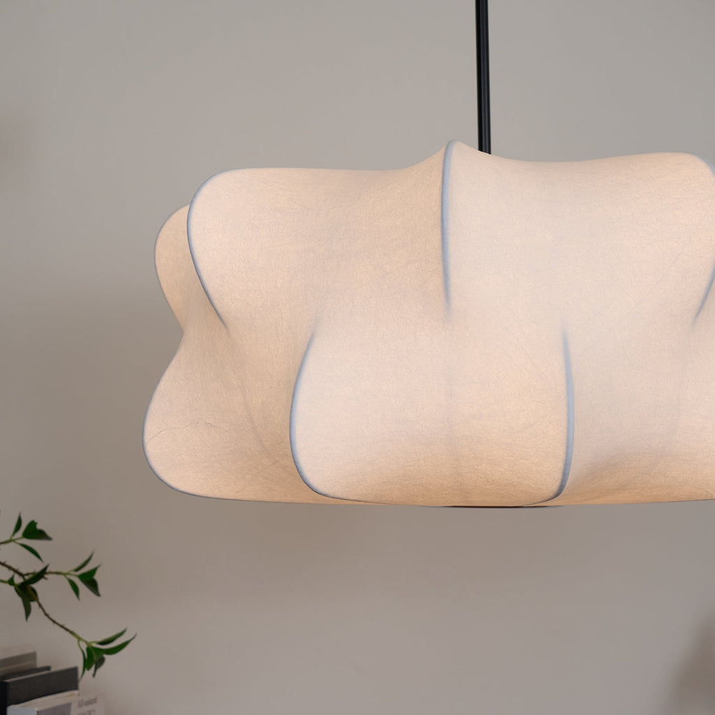 Cloud-shaped silk pendant light hanging above a table