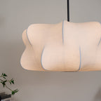 Cloud-shaped silk pendant light hanging above a table