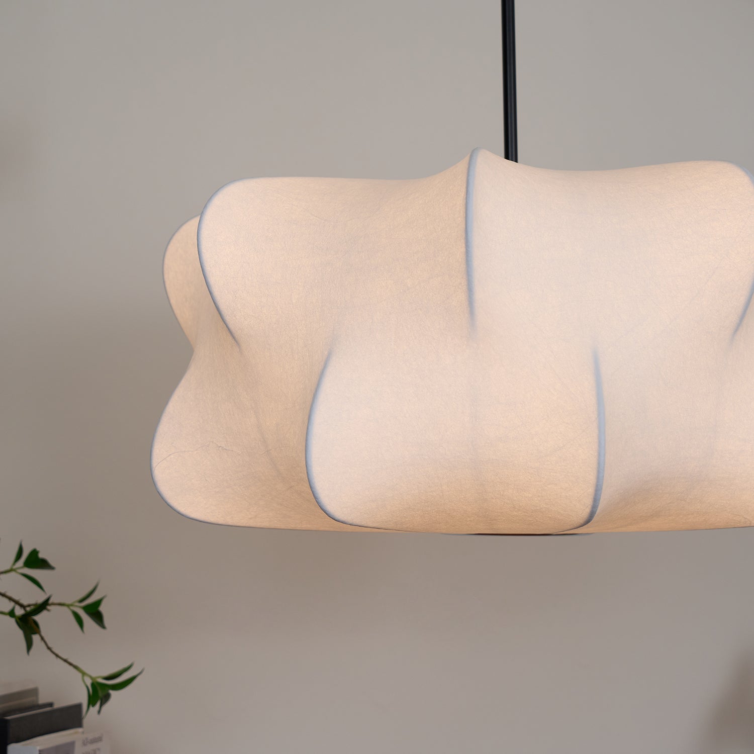 Cloud-shaped silk pendant light hanging above a table