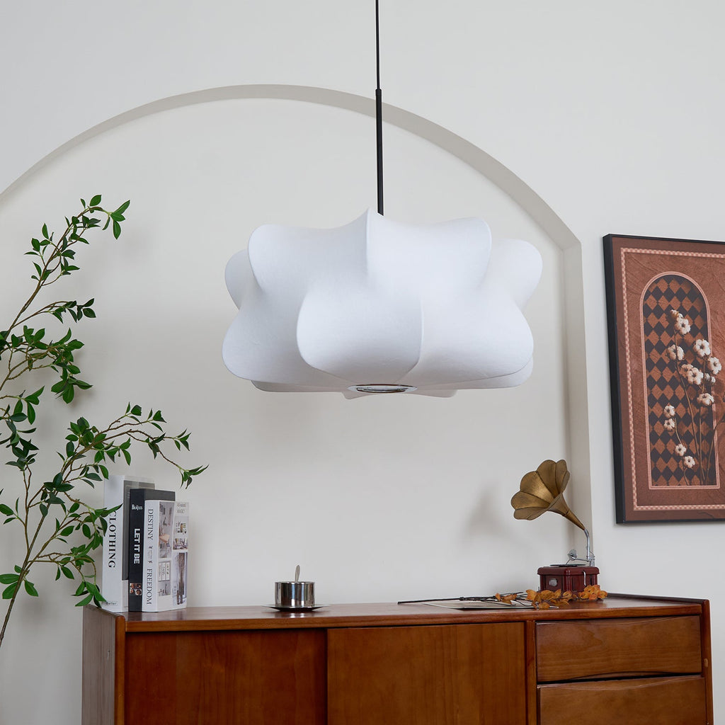 Elysia pendant light casting a warm, organic glow over a table