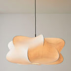 Elysia pendant light with a silk cocoon shade glowing above a dining table