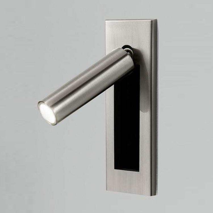 Embedded bedside sconce head turned to direct warm reading light