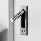 Embedded bedside sconce with adjustable head in a dark finish