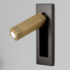 Folding bedside wall sconce angled to cast light over an open book