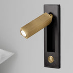 Folding reading wall light angled downward over bedside pages