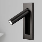 Bedside wall reading light folded flat against a painted wall