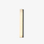 Kristy alabaster wall lamp tilted on an off-white studio background, stone face softly lit.