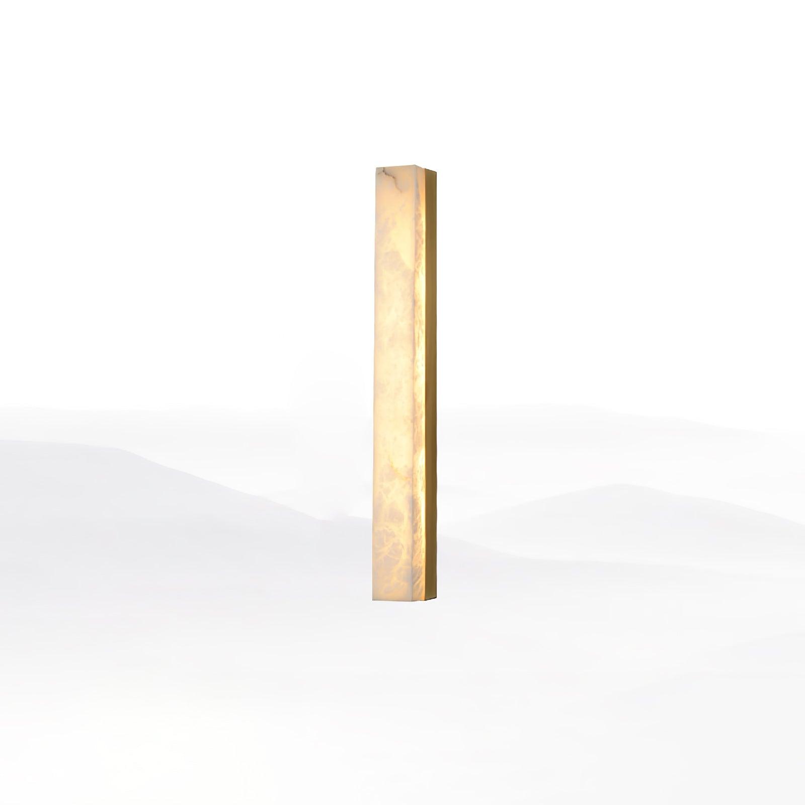 Brass-framed Kristy alabaster wall lamp, lit, angled studio view showing the slim brass edge rail.