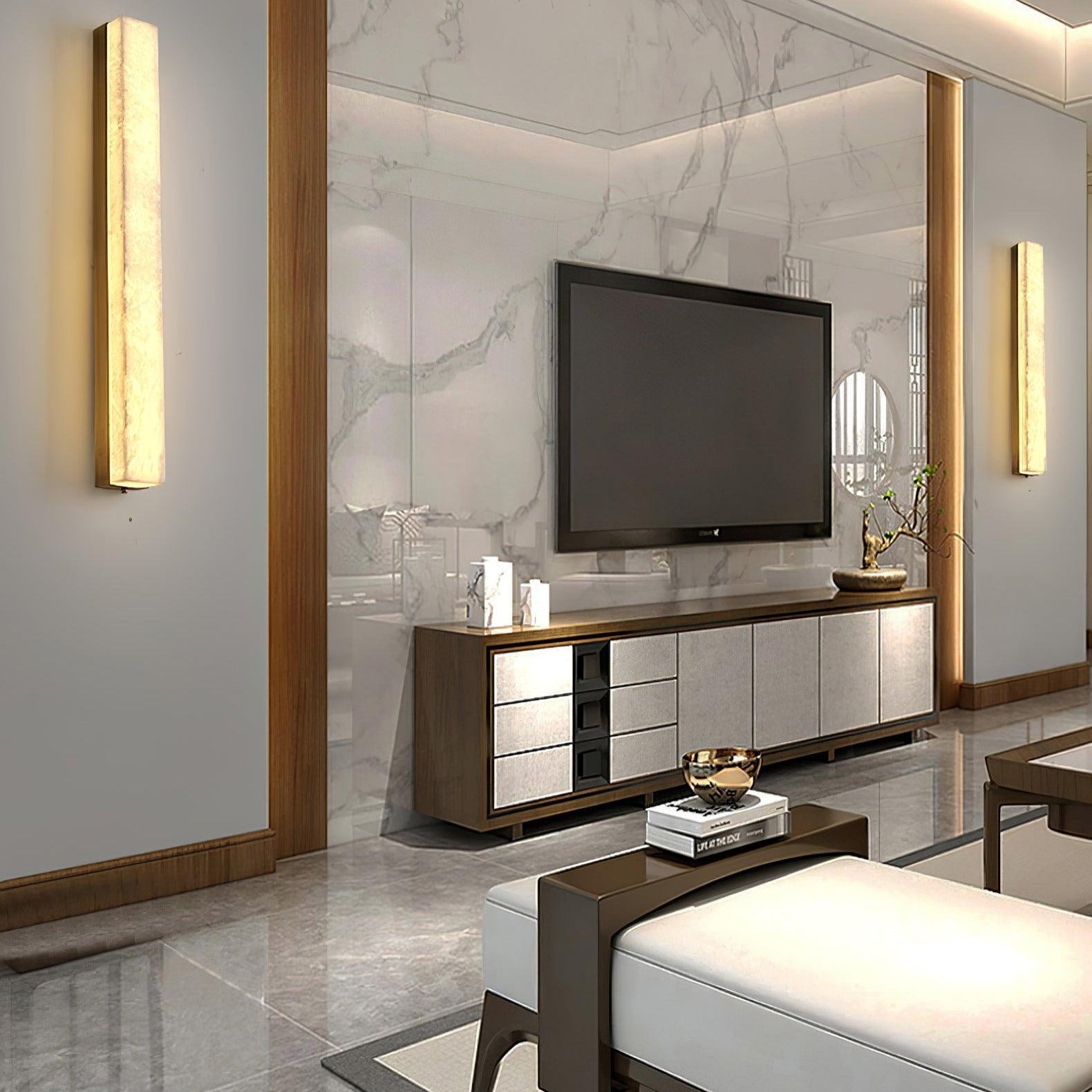 A pair of Kristy wall lamps lit either side of a marble media wall in a living room.