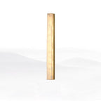 Brass-framed Kristy alabaster wall lamp in its tallest size, lit, shown against plain white.