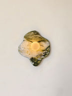 Glowing warm within a narrow crop, this Clérachic wall light's puddle-shaped marble shows deep green striations across its face.