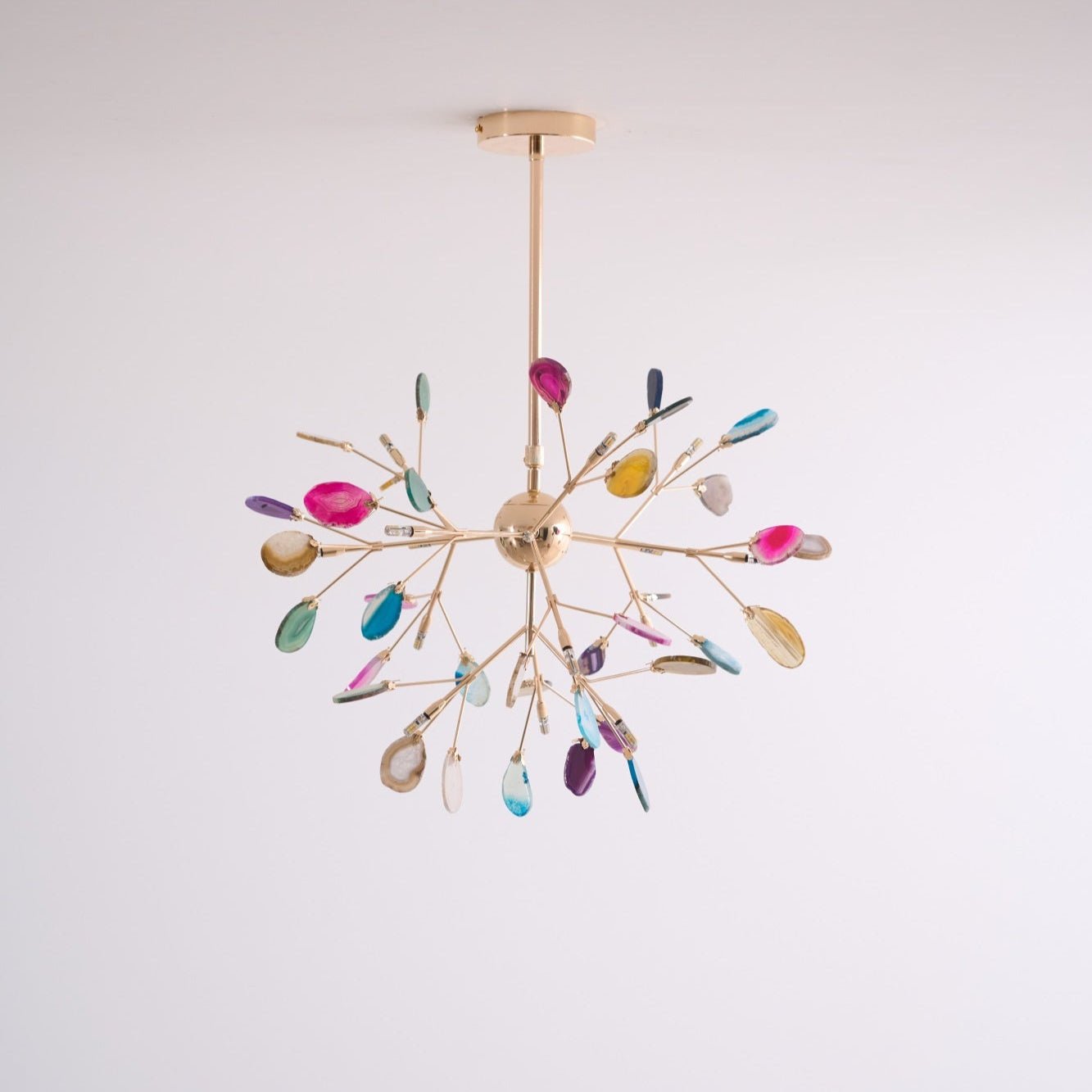 Agate chandelier glowing warmly against a neutral wall