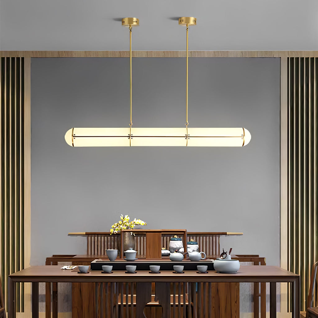 Linear pendant light suspended in a minimal architectural room