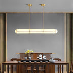 Linear pendant light suspended in a minimal architectural room