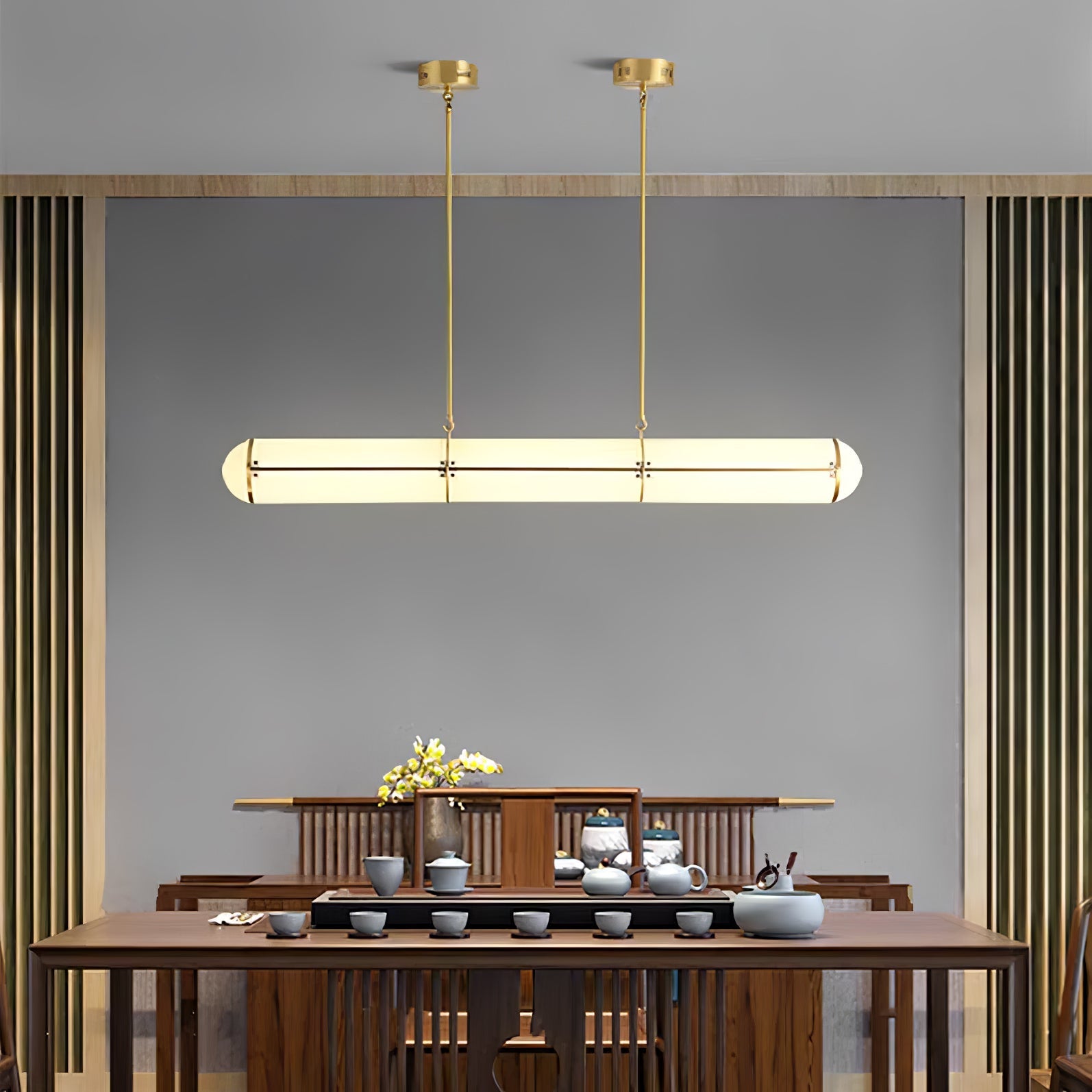 Linear pendant light suspended in a minimal architectural room