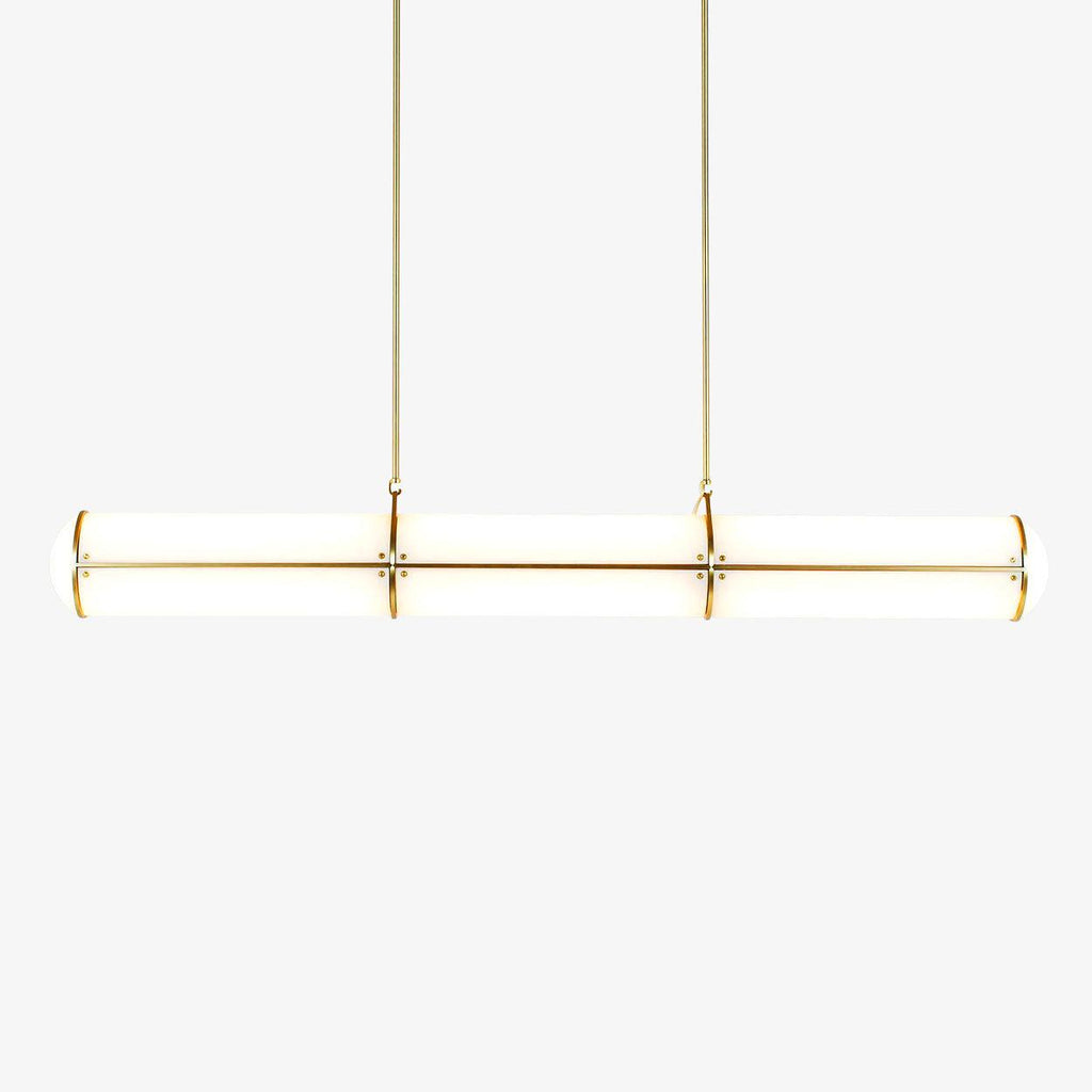 Cylindrical linear pendant light shown lit above a table