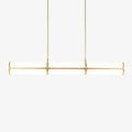 Cylindrical linear pendant light shown lit above a table