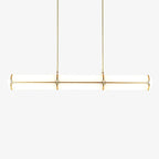 Cylindrical linear pendant light shown lit above a table