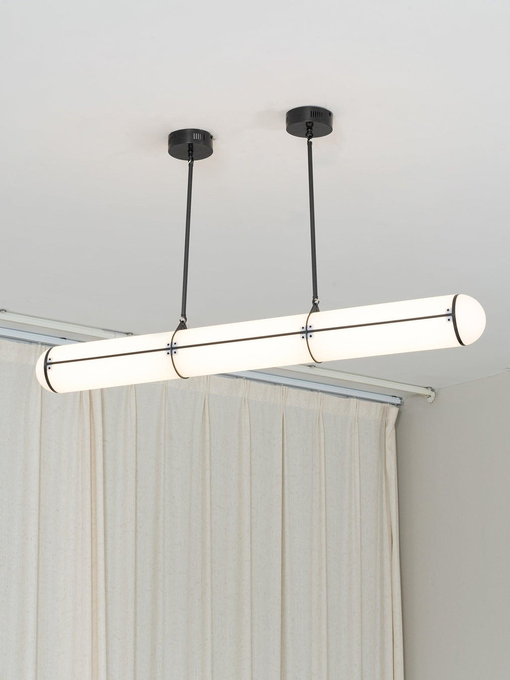 Linear pendant light glowing in a modern architectural interior