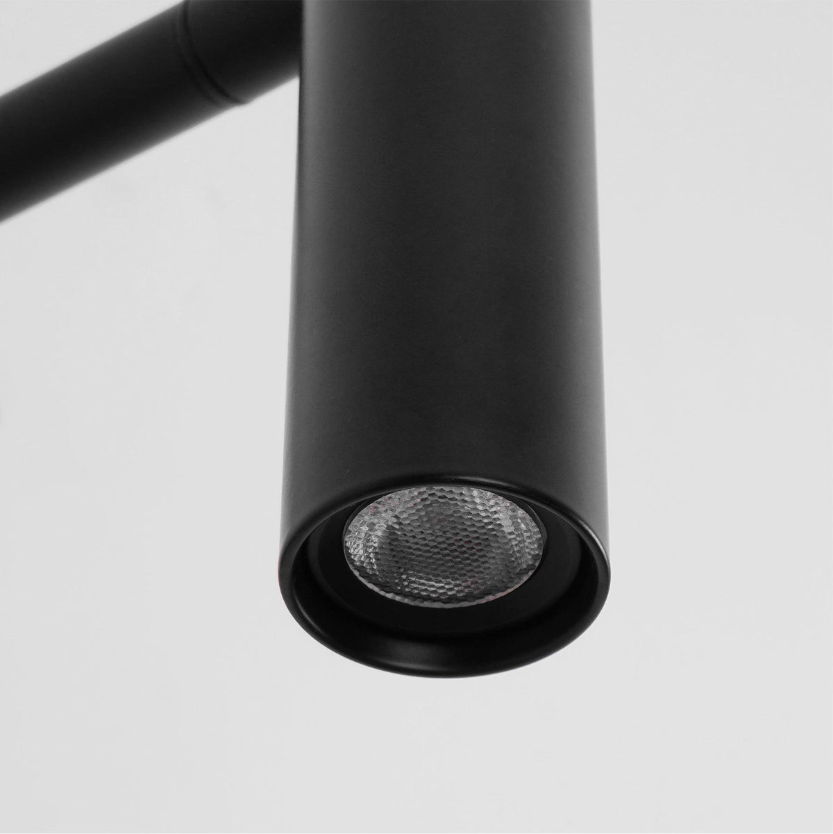 Close-up of the LED lens inside the head of this black Clérachic wall sconce.