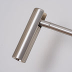 Close-up of the pivoting joint on this Clérachic wall sconce, in a brushed sand nickel finish.