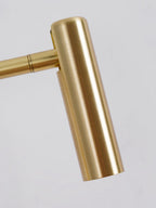 Close view of the brushed gold arm and swivel joint on this Clérachic wall sconce.