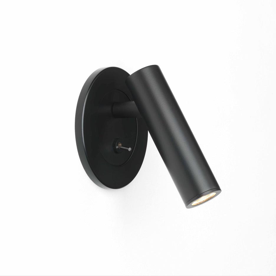 Recessed wall sconce with pivoting LED arm in a styled interior