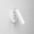 Recessed metal wall sconce casting warm directed light
