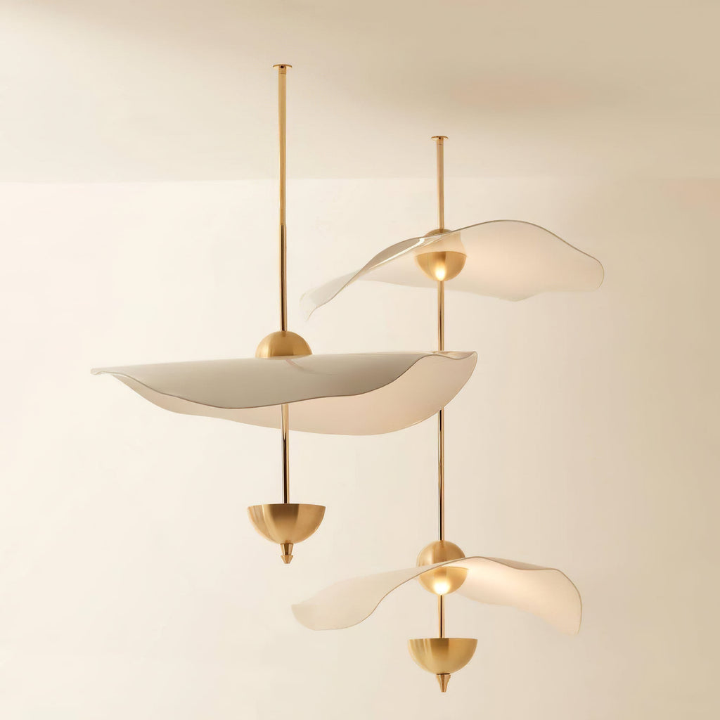 Envolee Double Biscuit gold and white pendant light glowing warmly over a living space