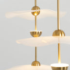 Close detail of the Envolee Double Biscuit pendant's layered white shade and gold frame