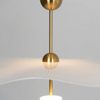 Envolee Double Biscuit pendant light in gold and white hanging above a styled dining table