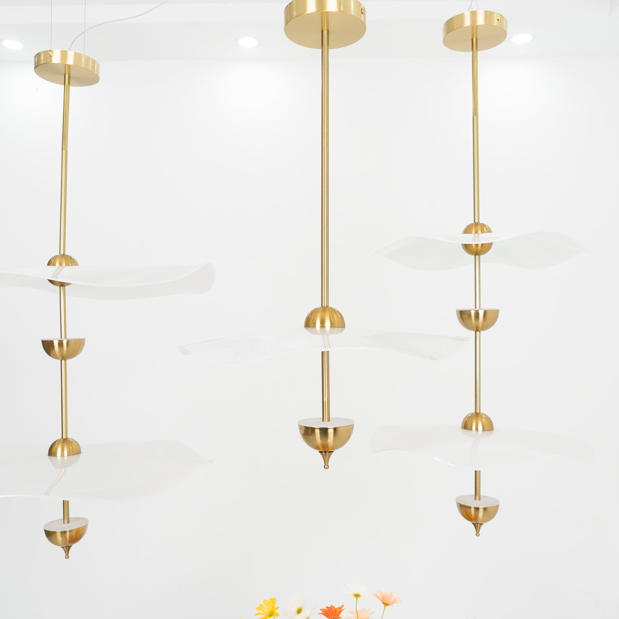 Envolee Double Biscuit pendant light in gold and white hanging above a styled dining table
