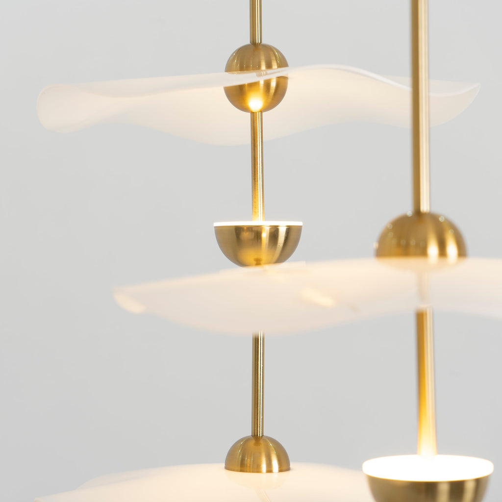 Close detail of the Envolee Double Biscuit pendant's layered white shade and gold frame