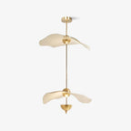 Envolee Double Biscuit gold and white pendant light glowing warmly over a living space