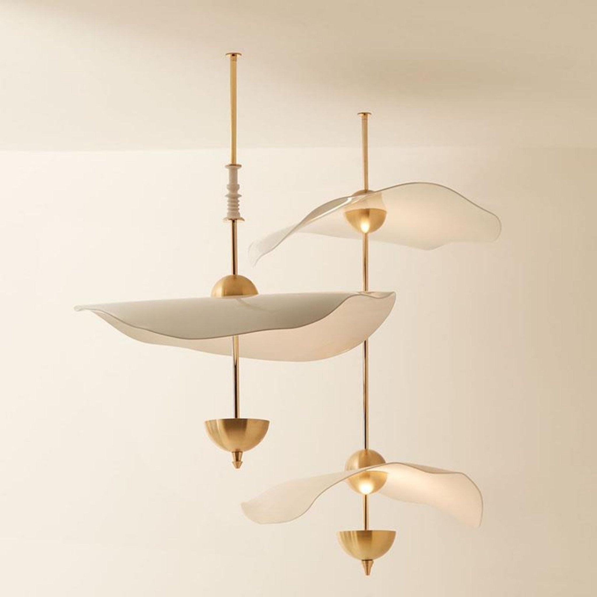 Close detail of the Envolee Double Biscuit pendant's layered white shade and gold frame