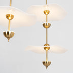 Close detail of the Envolee Double Biscuit pendant's layered white shade and gold frame