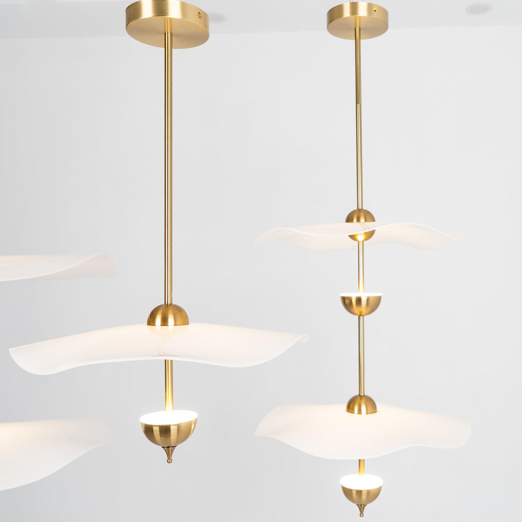 Close detail of the Envolee Double Biscuit pendant's layered white shade and gold frame