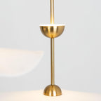 Envolee Double Biscuit pendant light in gold and white hanging above a styled dining table