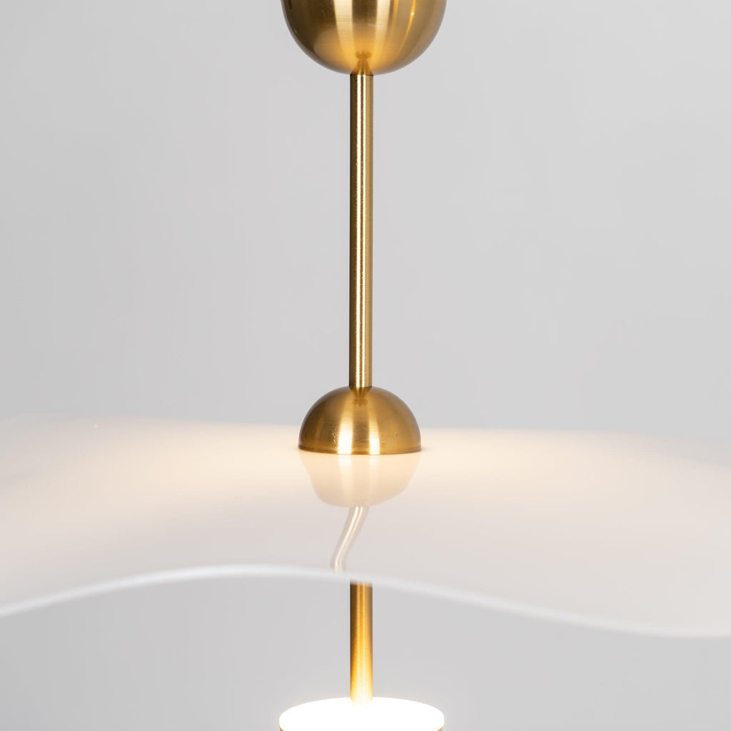 Close detail of the Envolee Double Biscuit pendant's layered white shade and gold frame