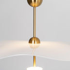 Close detail of the Envolee Double Biscuit pendant's layered white shade and gold frame