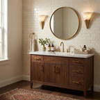 Flanking a round brass-framed mirror on white brick, these Clérachic sconces glow above a walnut vanity in brushed brass.