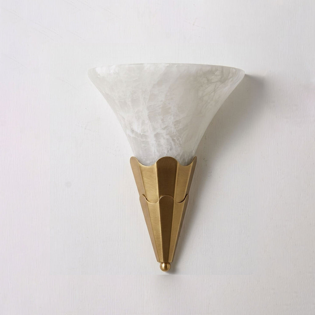 Lit against a plain white wall, this Clérachic sconce's alabaster shade glows above a brushed brass fluted base.