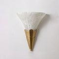 Lit against a plain white wall, this Clérachic sconce's alabaster shade glows above a brushed brass fluted base.